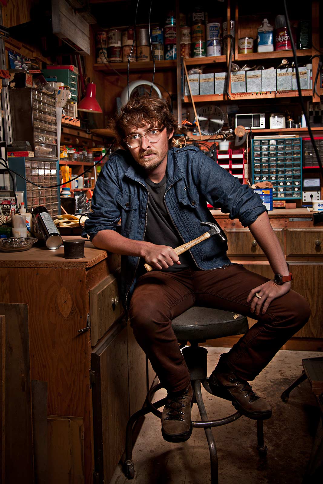 An attractive young hipster poses in his woodworking workshop in Brooklyn NY