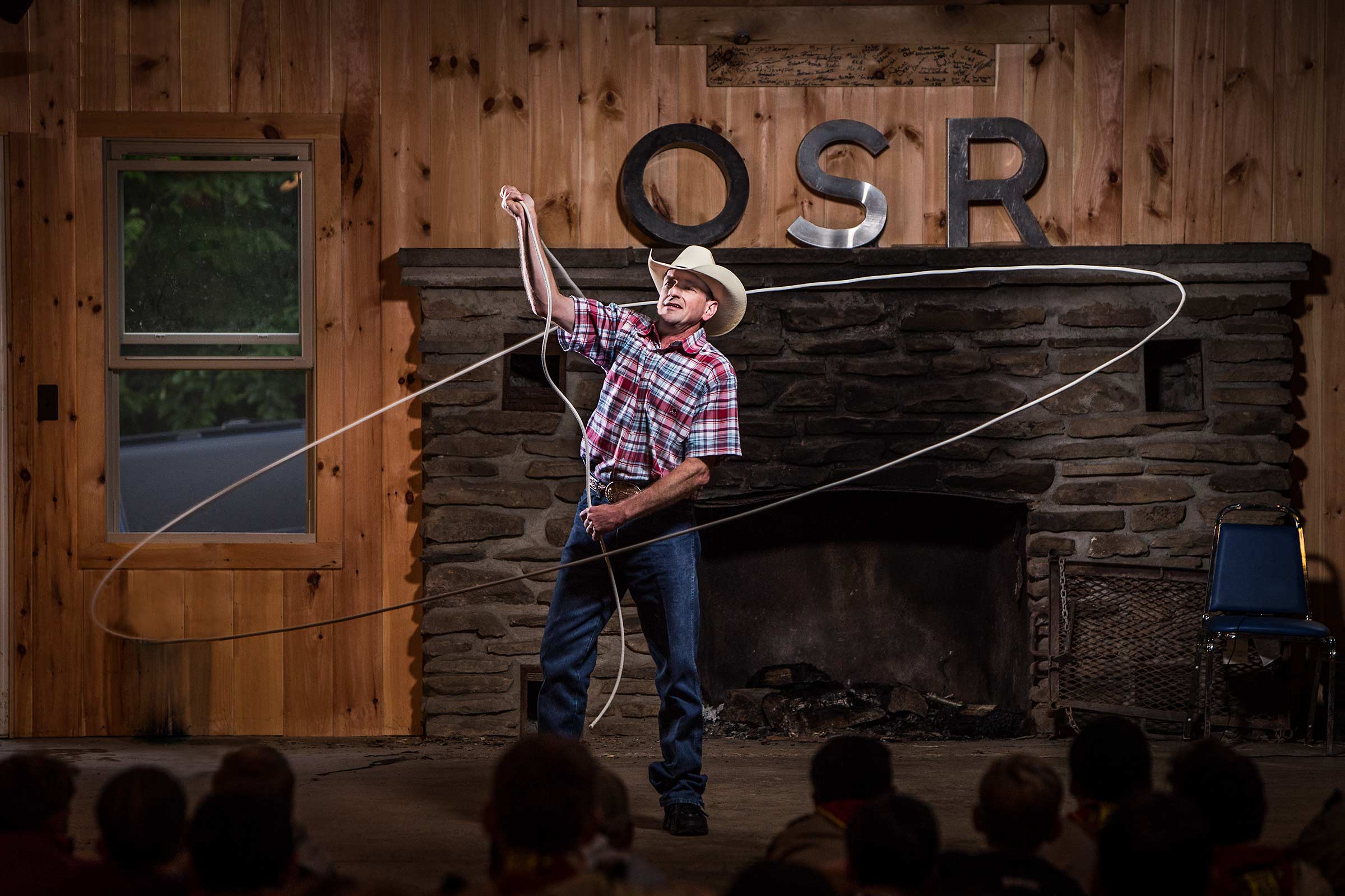 professional rope wrangler twirling rope overhead at boyscout camp in New York