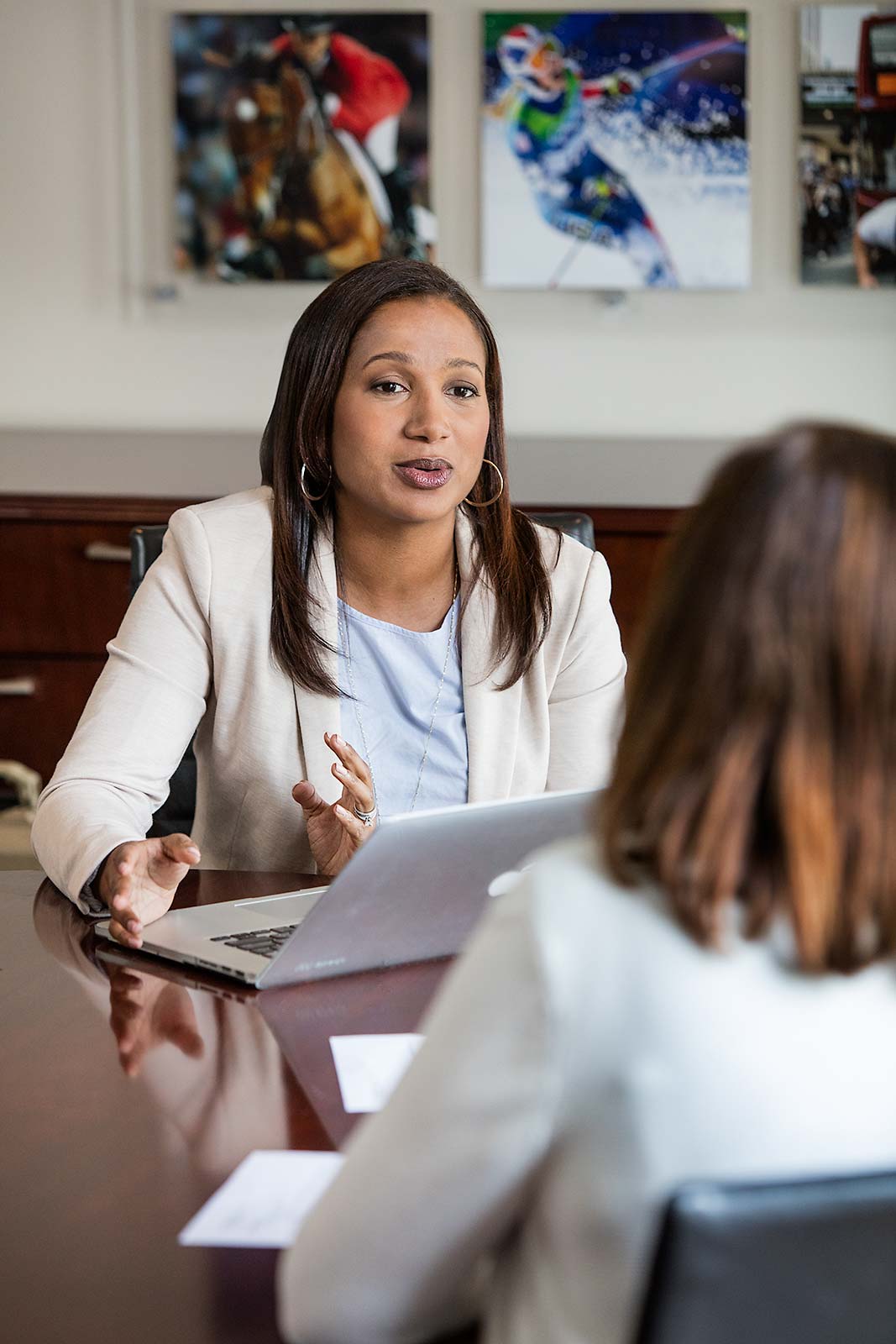 Female African American Lawyer conversing with clients in NYC Office