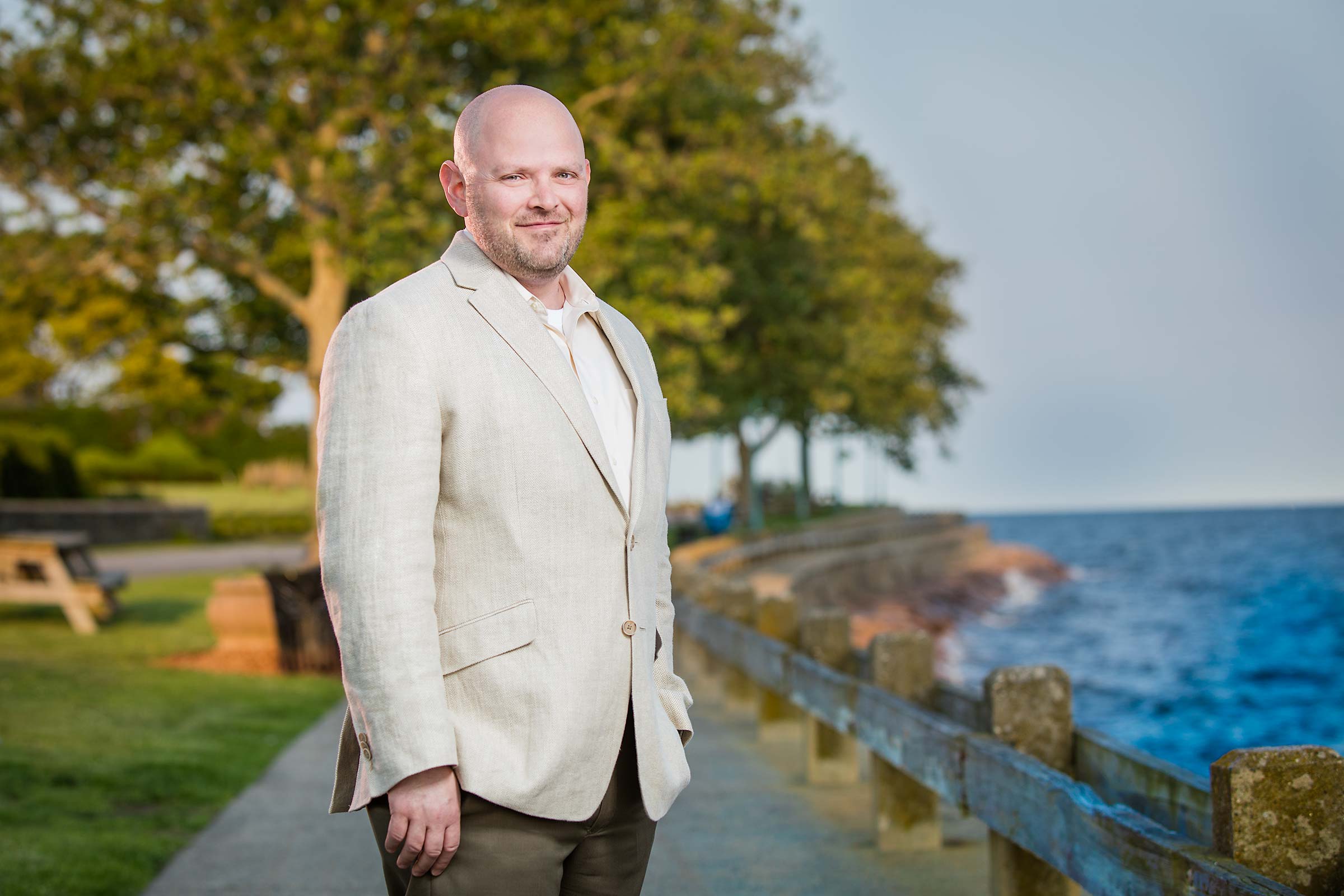 Casual outdoor portrait of municipal Technology Director near ocean in Connecticut
