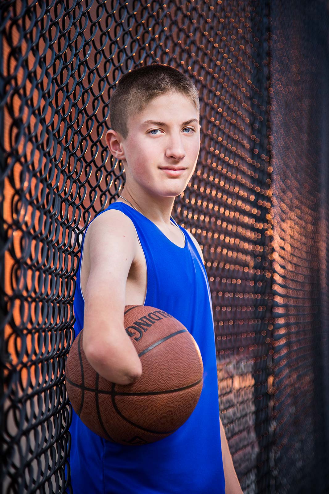 powerful portrait of a young athlete with disability holding basketball in Connecticut