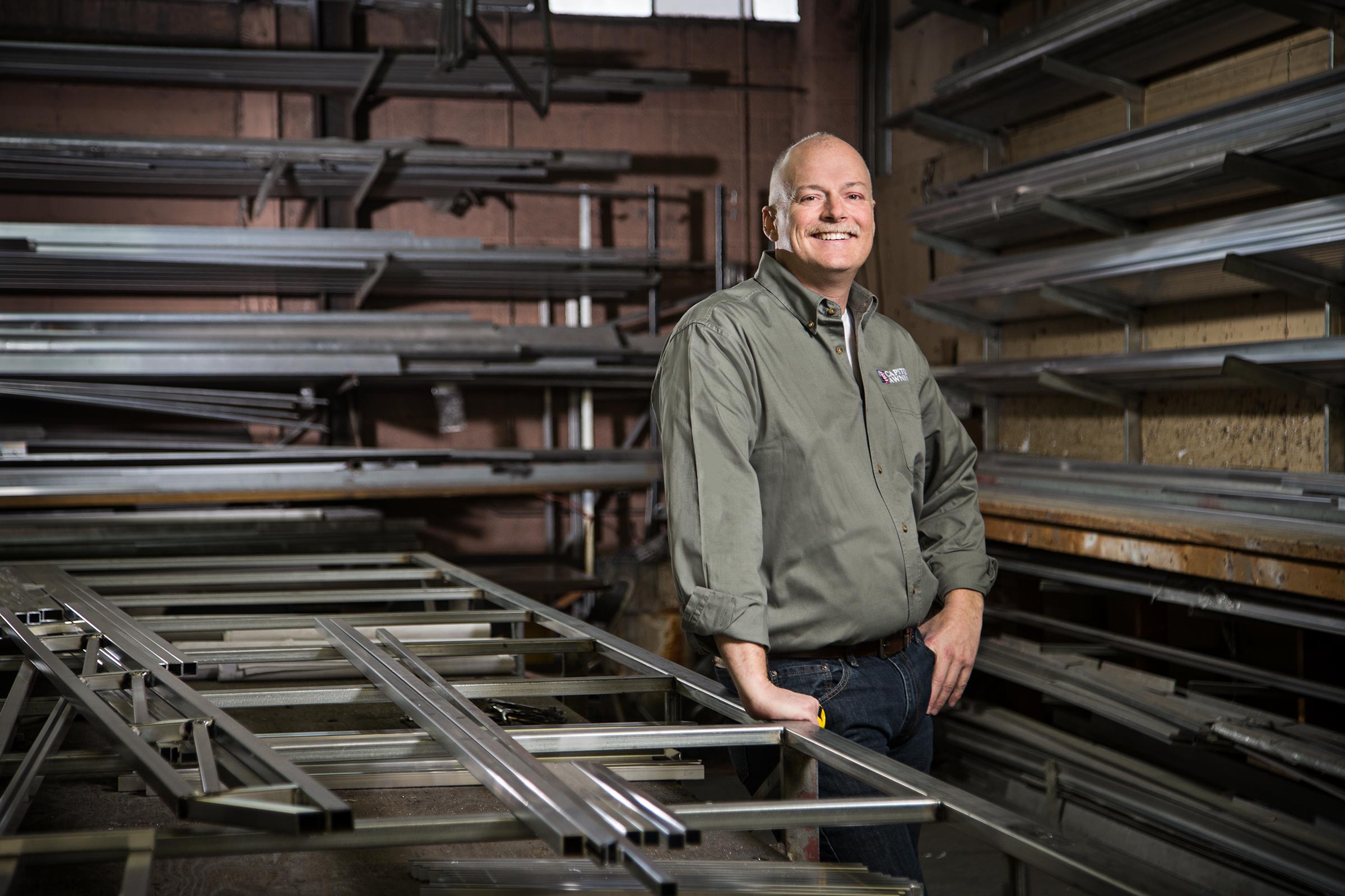 Small business owner surronded by steel in workshop in Queens, New York