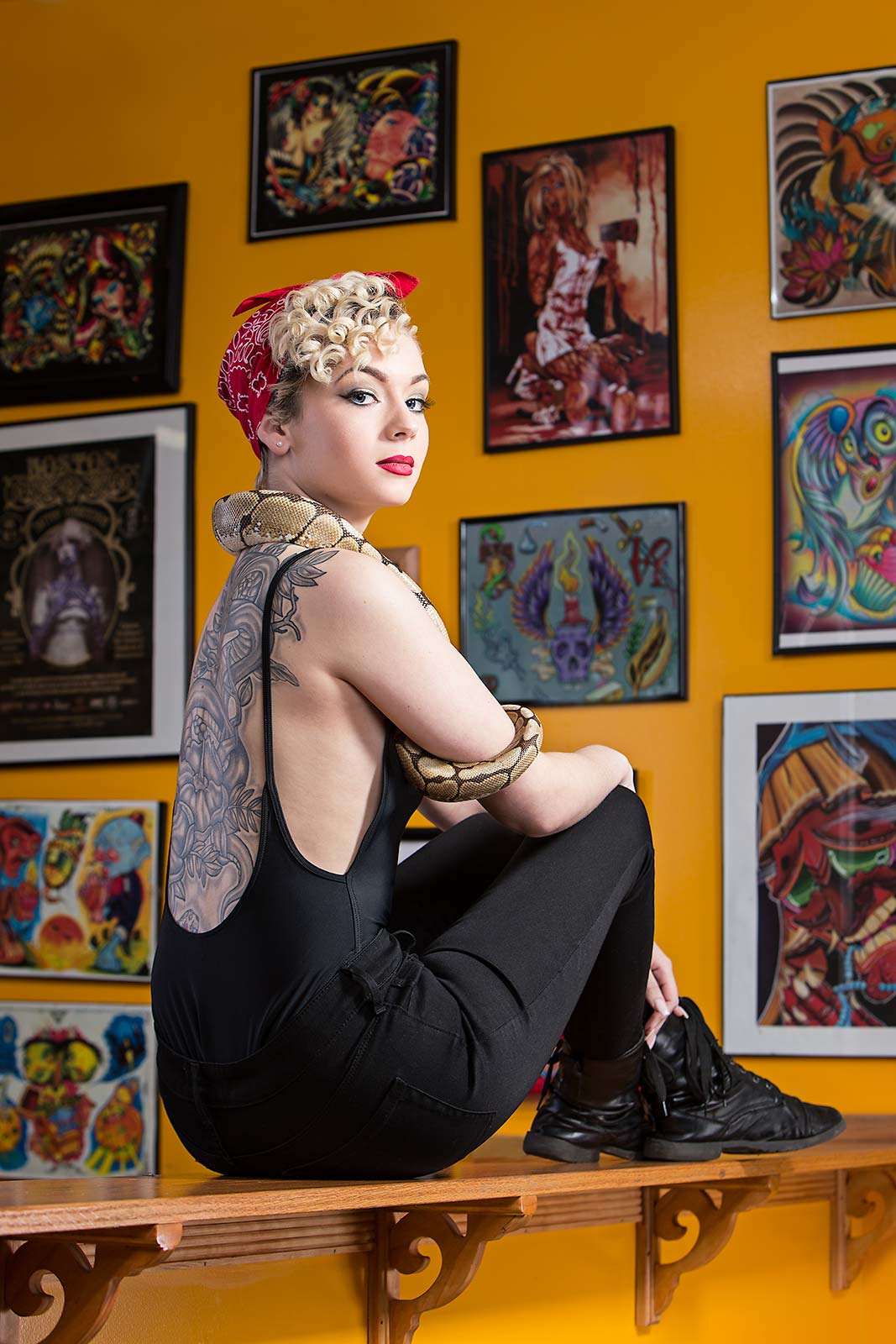 A young woman shows off her tattoos at a tattoo studio in Massachusetts
