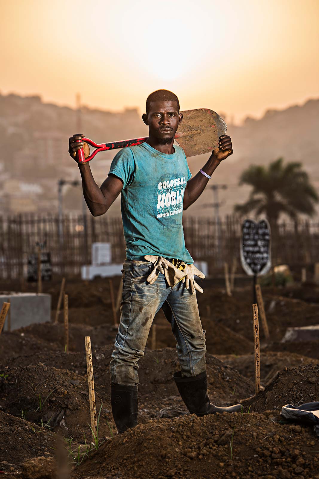 A black male worker at an Ebola graveyard at sunset in Freetown Sierra Leone
