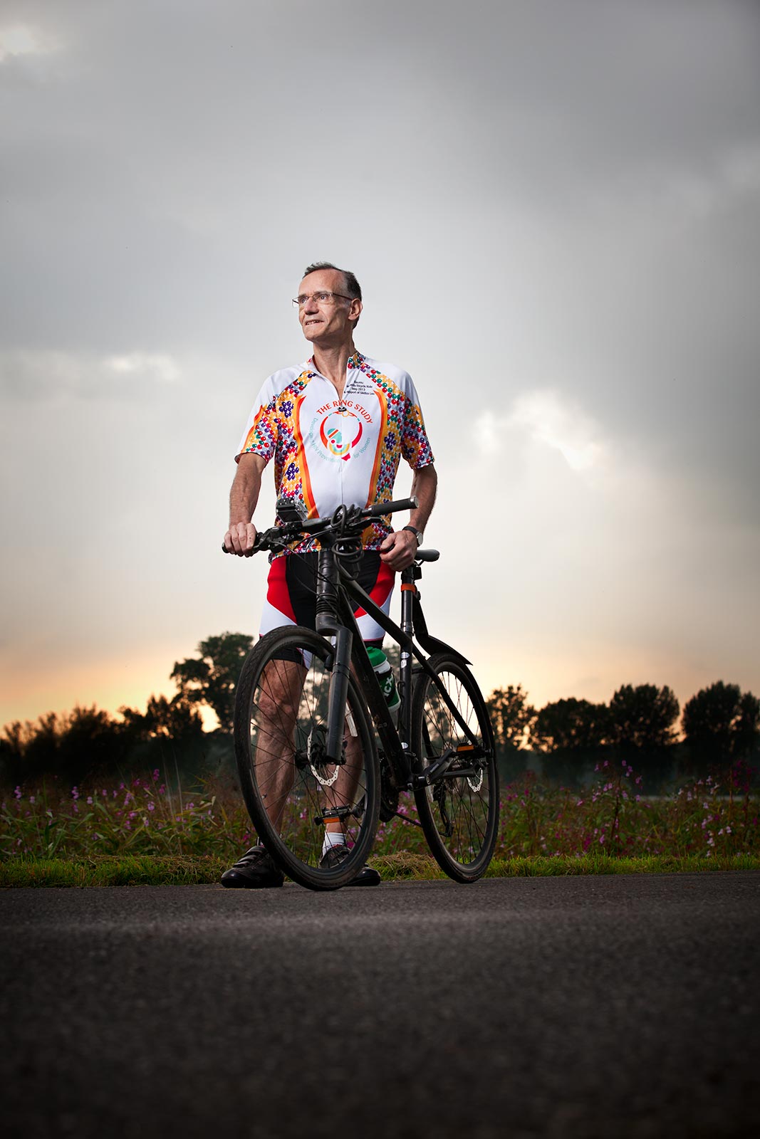 sunset portrait of  male senior posing with bicycle in Europe for Phamaceutical brand 