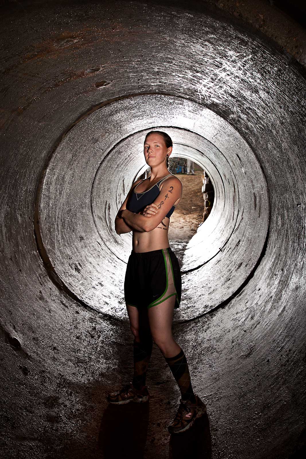 A fit athletic young woman poses in a tube during an adventure race in Connecticut