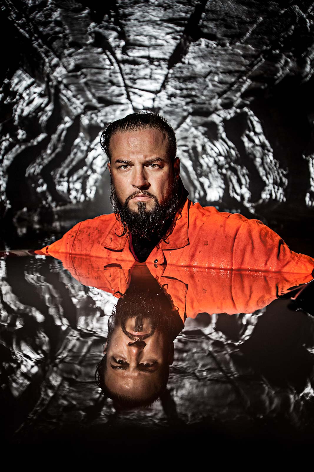Portrait with reflection of worlds most adventurous person Justin Fornal in deep water in cave