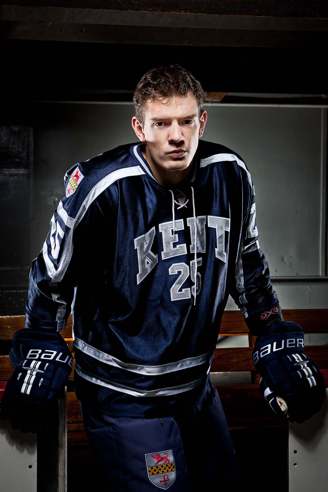 Impactful portrait of a rising hockey star wearing uniform in Hockey rink