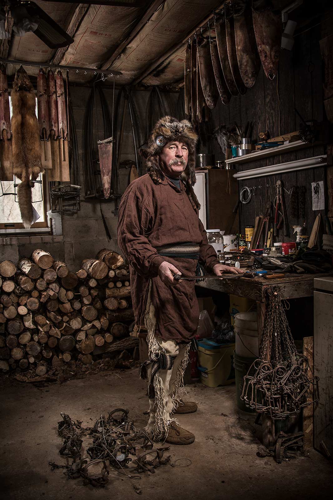 A older man dressed in tradional trapper clothing in workshop in New Jersey